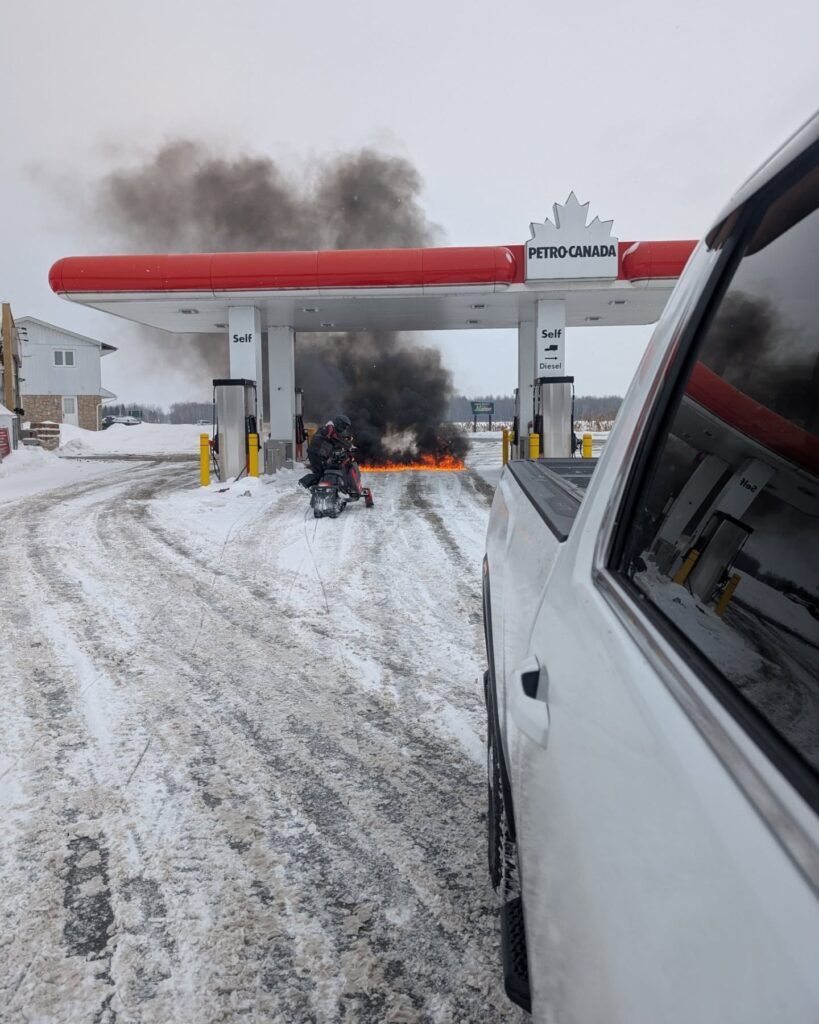 A snowmobile caught fire while refueling at a gas station, but quick action from bystander Richard Quinn prevented further damage. Emergency responders arrived on the scene, and no injuries were reported.