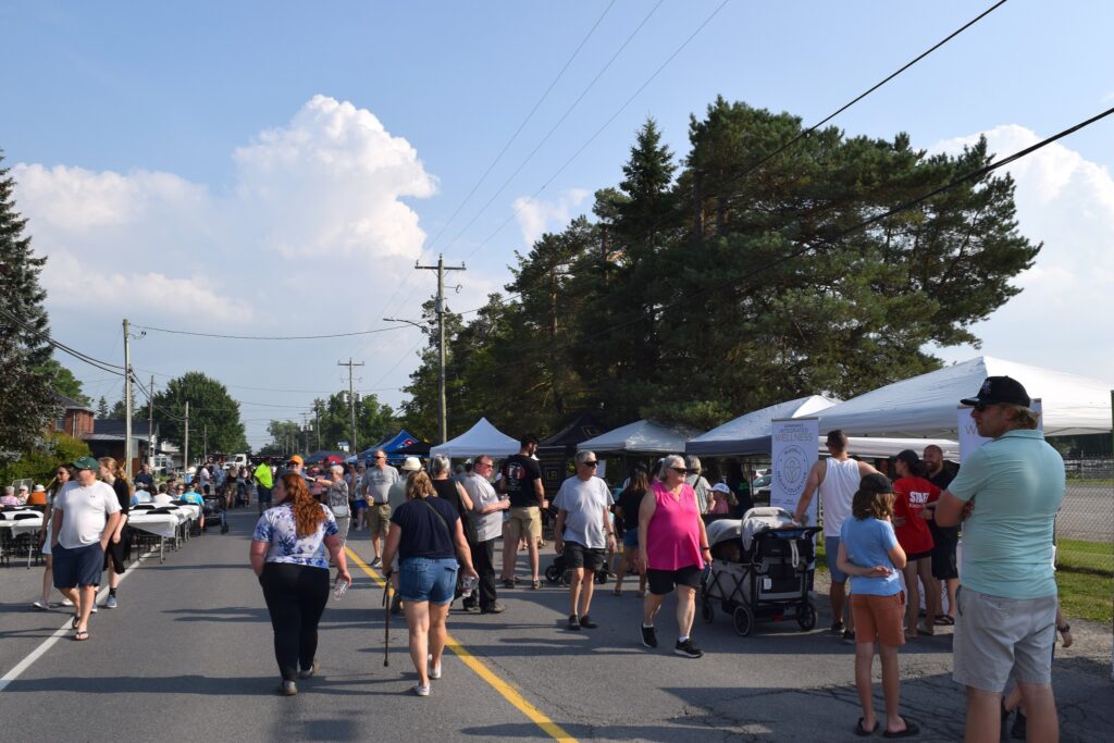 Residents stroll through downtown Russell during the Meet Me on Main Street event, enjoying local vendors, food, and live entertainment in a lively celebration of community spirit.