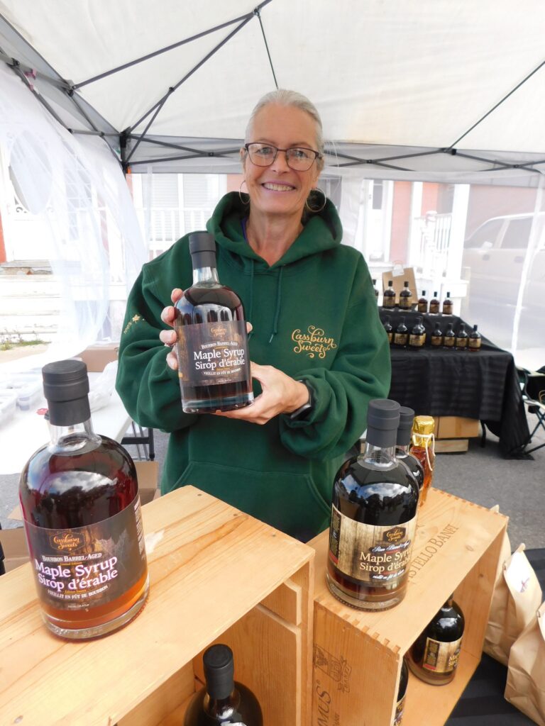 7 Lucie Lamoureux of Cassburn Sweets in Vankleek Hill proudly displays her special homecrafted bourbon-infused maple syrup. Sweet samples of the syrup proved very popular with people stopping by her kiosk during the Festival of Flavours.