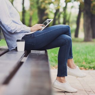 Young woman using digital tablet outdoors
