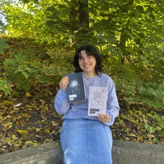 L'autrice d'Embrun, Amélie Bouthillier, tenant ses deux livres, poèmes perdus (à gauche) et poèmes de guérison (à droite).