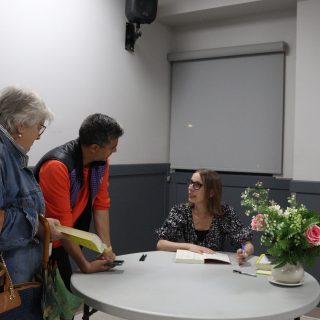 Nita Prose chats with fans as she signs their copies of her novels following her talk in Russell.