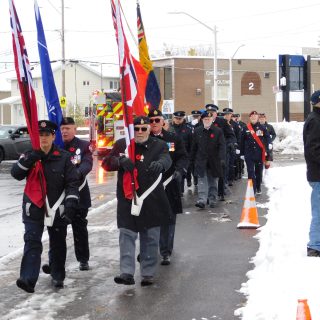 Members of the Hawkesbury Royal Canadian Legion Branch, the 57 SDG Islanders Army Cadet Corp, police and other emergency service personnel march towards the Cenotaph on a blustery November 11 morning for Remembrance Day.