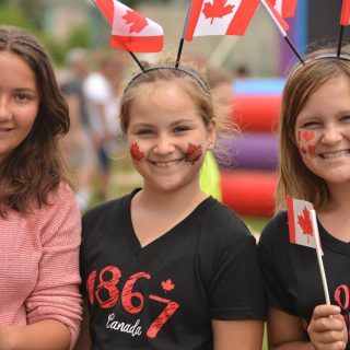 Keaunna Rock (left), Kierstyn Foster-Kampman-Kissy and Morgana Foster-Kampman-Gona patiently line up for the inflatable slide, one of the many games for children of all ages at Clarence-Rockland's Canada Day celebration at Simon Park