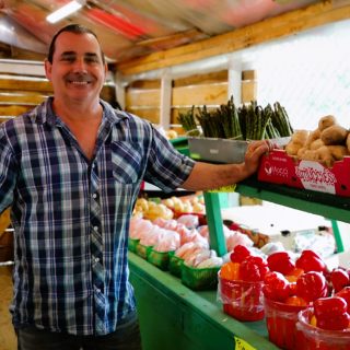 Luc Gerard displays some of the products he sells at the C&L Corner Market, on the corner of Highway 17 and Edward Street, opposite the Esso service station. Gerard has been running this fruit and vegetable stand for around ten years.